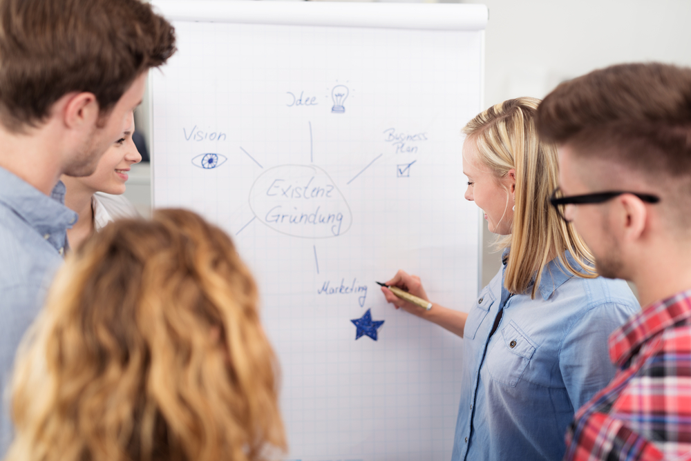 Group of Young Office People Having a Brainstorming Session Using a Poster Paper for Some Inputs Inside the Office.-1